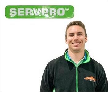 Justin, SERVPRO employee, green SERVPRO sign behind male