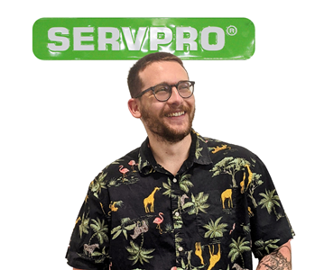Marc posing for SERVPRO photo on white wall 
