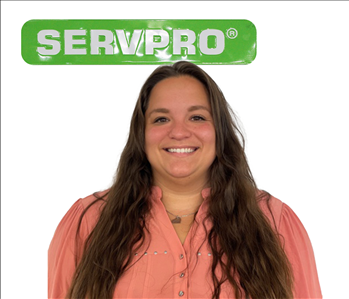 Jazmyne Higdon, female SERVPRO employee under green sign